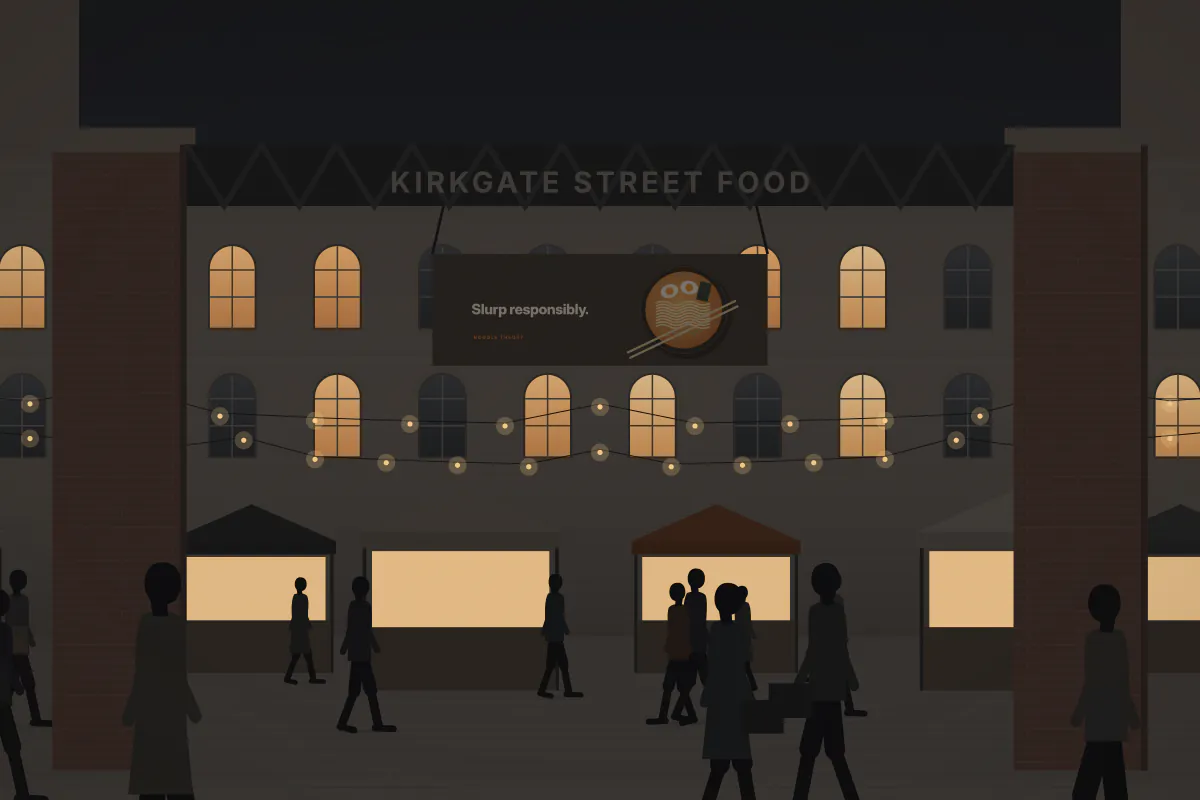Banner pitch at a weekend street-food market — at night